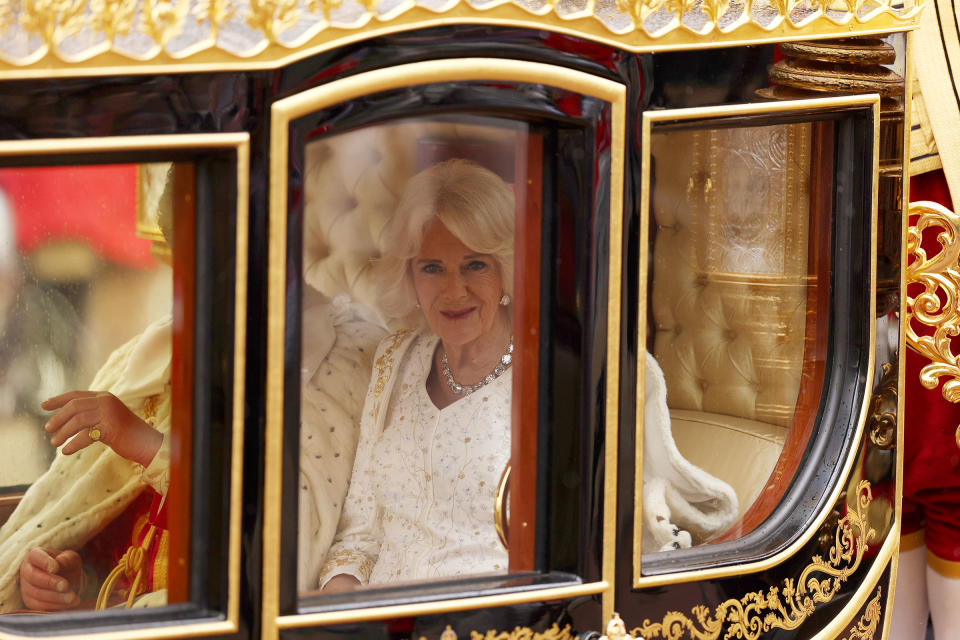 Camilla, the Queen Consort, travels in the Diamond Jubilee Coach flanked by over a thousand Armed Forces route liners and The Sovereign's Escort of the Household Cavalry on route to Westminster Abbey.<span class="copyright">Richard Heathcote—Pool/AP</span>