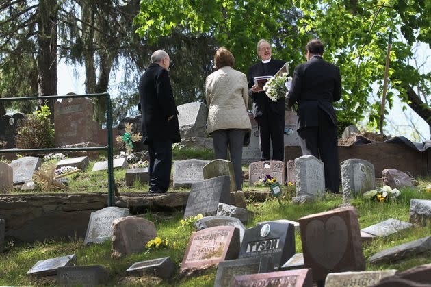 Pet chaplain David James conducts a graveside service for Justin, a 12-year-old beagle-hound, at the Hartsdale Pet Cemetery in April 2012. Attorney Spencer Warren brought Justin from Annandale, Virginia to be buried. (Photo: John Moore via Getty Images)