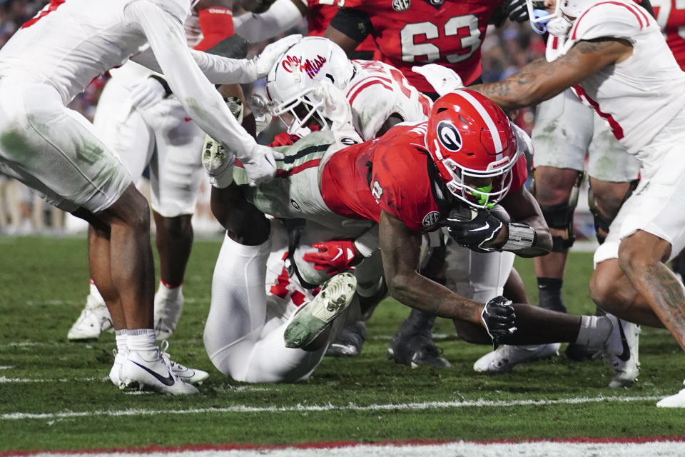 Georgia running back Kendall Milton (2) dives over the goal line for a touchdown during the first half of an NCAA college football game against against Mississippi, Saturday, Nov. 11, 2023, in Athens, Ga. (AP Photo/John Bazemore)