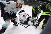 Seattle Kraken center Jaden Schwartz (17), and right wing Oliver Bjorkstrand (22) battle Dallas Stars center Wyatt Johnston (53) and defenseman Ryan Suter (20) for the puck in the second period during an NHL hockey game on Saturday, April 13, 2024, in Dallas. (AP Photo/Richard W. Rodriguez)