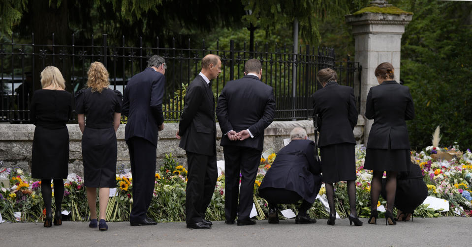 Members of the British Royal family view the floral tributes to Queen Elizabeth II outside the gates of Balmoral Castle in Aberdeenshire, Scotland Saturday, Sept. 10, 2022. Queen Elizabeth II, Britain's longest-reigning monarch and a rock of stability across much of a turbulent century, died Thursday after 70 years on the throne. She was 96. (AP Photo/Alastair Grant)