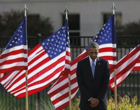 U.S. President Barack Obama pauses during a moment of silence at the Pentagon in remembrance of those who lost their lives in the 9/11 attacks, in Washington September 11, 2014. REUTERS/Gary Cameron