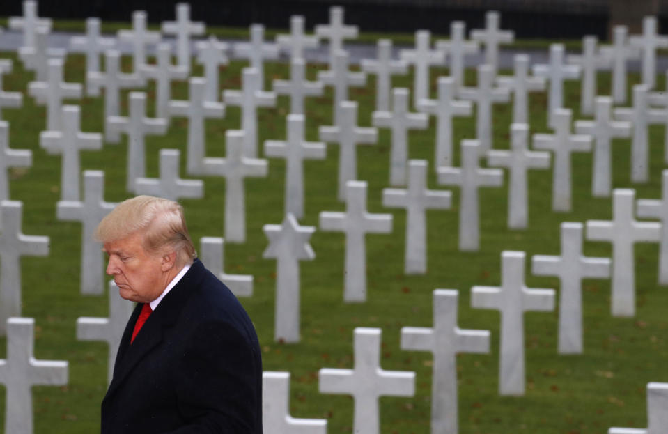 President Donald Trump is backdropped by headstones as he prepares to speak during an American Commemoration Ceremony, Sunday Nov. 11, 2018, at Suresnes American Cemetery near Paris. Trump is attending centennial commemorations in Paris this weekend to mark the Armistice that ended World War I. (AP Photo/Jacquelyn Martin)