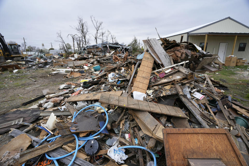 One year after a deadly tornado struck, debris of homes and businesses awaits removal in Rolling Fork, Miss., on March 22, 2024. Buildings throughout town remain boarded up, and the remnants of destroyed properties dot the landscape. The tornado killed 14 residents and reduced the town to rubble as it charted a merciless path across one of the country’s poorest regions. (AP Photo/Rogelio V. Solis)