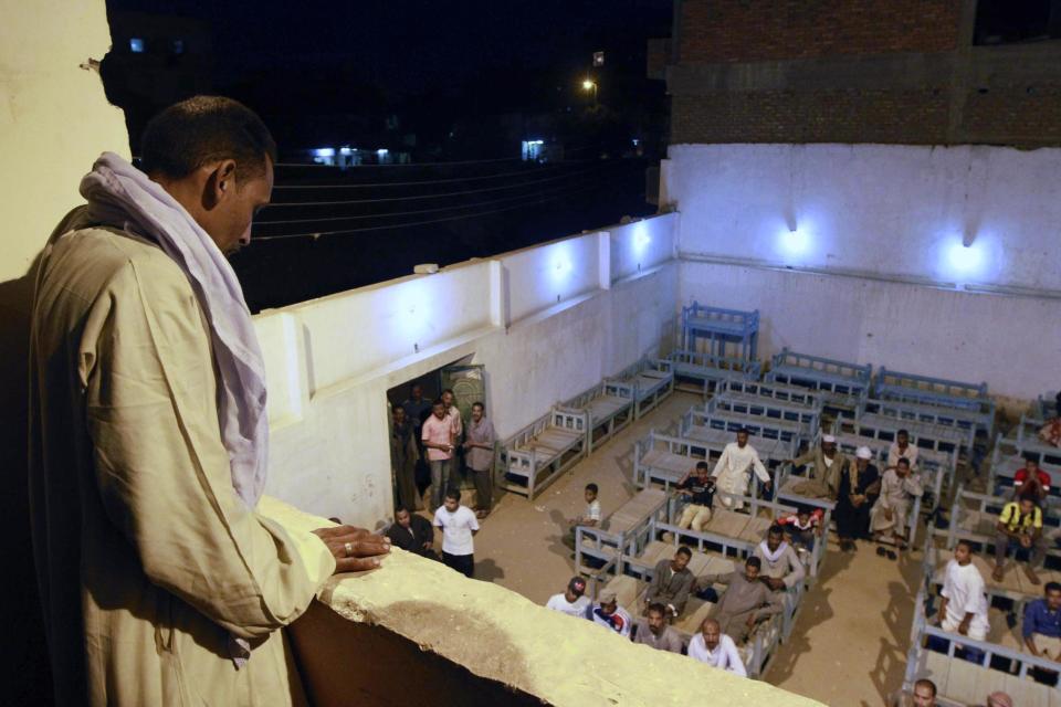 Arab family members gather in a communal family space to discuss plans after a truce expires following tribal feuding in Aswan, Egypt, Tuesday, April 9, 2014. Telephone and internet networks were briefly shut down to Egypt's southern province of Aswan for several hours, as authorities moved to try to end a bloody tribal feud that killed 26 people over the past days, security officials and residents said Tuesday.(AP Photo/Sabry Khaled, El Shorouk Newspaper) EGYPT OUT