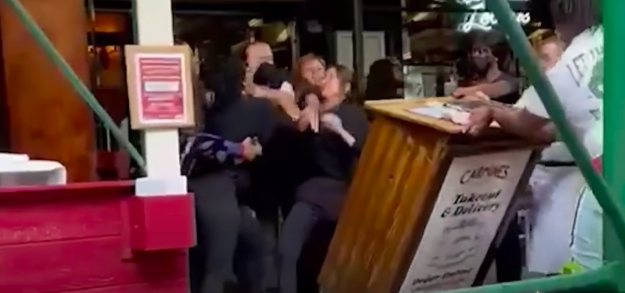 A video shot by an onlooker and shared on social media showed three women attacking a New York City restaurant hostess. The women have now claimed that racial slurs were used. Screengrab (NBC New York)