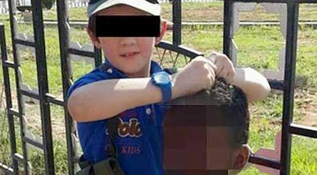 A boy believed to be Khaled Sharrouf’s son holds the decapitated head of a soldier. Photo: Twitter