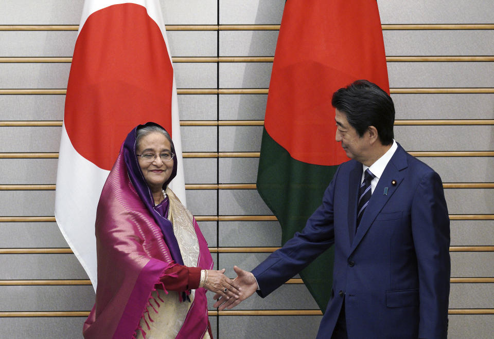 Bangladesh's Prime Minister Sheikh Hasina, left, shakes hands with Japan's Prime Minister Shinzo Abe at the start of their meeting at Abe's official residence Wednesday, May 29, 2019, in Tokyo. Hasina is wooing Japan for aid, trade and investment in a visit that highlights cordial relations with the administration of Abe. (AP Photo/Eugene Hoshiko, Pool)
