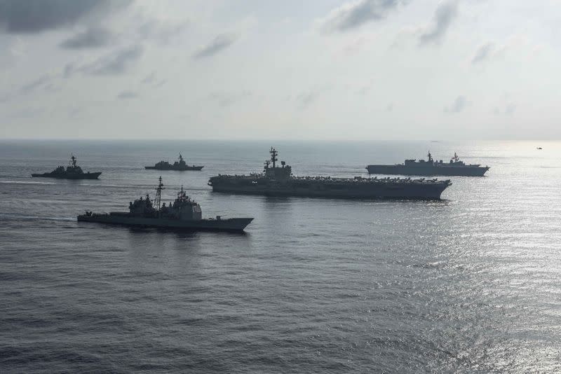 FILE PHOTO: The Ronald Reagan Strike Group ship's aircraft carrier USS Ronald Reagan conduct an exercise with the Japanese Maritime Self-Defense Force ships