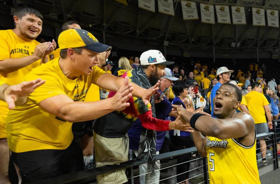 Trey Wade of the Aftershocks is congratulated by fans after hitting the game winning shot against the Beale Street Boys during The Basketball Tournament on Friday night. The Aftershocks were down by by 19 in the second half before completing a comeback with members of the 2013 Wichita State Final Four team watching from behind the bench.