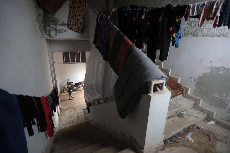 Laundry for Internally displaced people hangs inside an empty school and university compound used as shelter, in Azaz