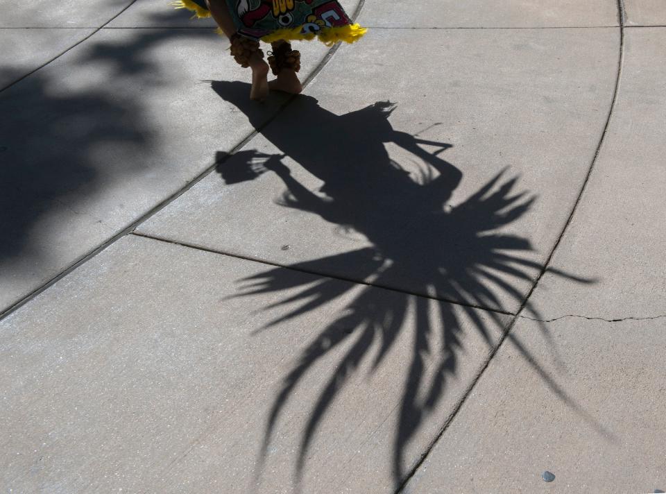 Veronica Villa casts her shadow on the ground as she performs with a group of Aztec dancers made up of dancers from, San Jose, Oakland, Colusa, Sacramento and Stockton who performed as a part of San Joaquin Delta College's Indigenous Peoples Day at the Delta campus in Stockton on Thursday, Oct. 6, 2022. The event celebrated the rich culture & history of First Nation peoples of this continent. The event was sponsored by the SJDCTA Social Justice and Equity Committee, the Associated Students of Delta College (ASDC), the Cultural Awareness Program (CAP), and the Chicanx/Latinx Faculty (CLF).