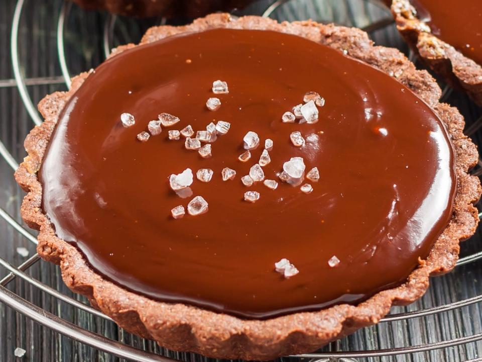 mini chocolate pie on wire rack with sea salt flakes on it