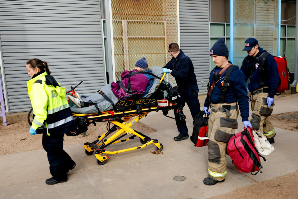 Paramedics transport a patient from the Homeless Alliance day shelter in Oklahoma City on Jan. 13.