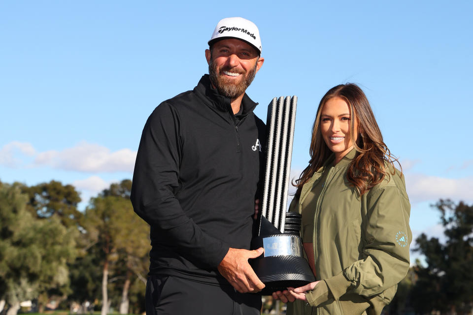 Dustin Johnson of 4Aces GC poses with wife Paulina Gretzky and the individual trophy after winning day three of the LIV Golf Invitational - Las Vegas at Las Vegas Country Club on Feb. 10, 2024 in Las Vegas, Nev. (Photo by Michael Reaves/Getty Images)
