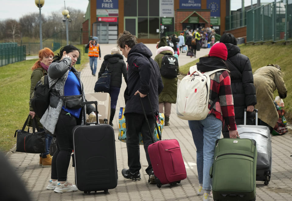 People return back to Ukraine at the border crossing in Medyka, southeastern Poland, Saturday, April 9, 2022. (AP Photo/Sergei Grits)