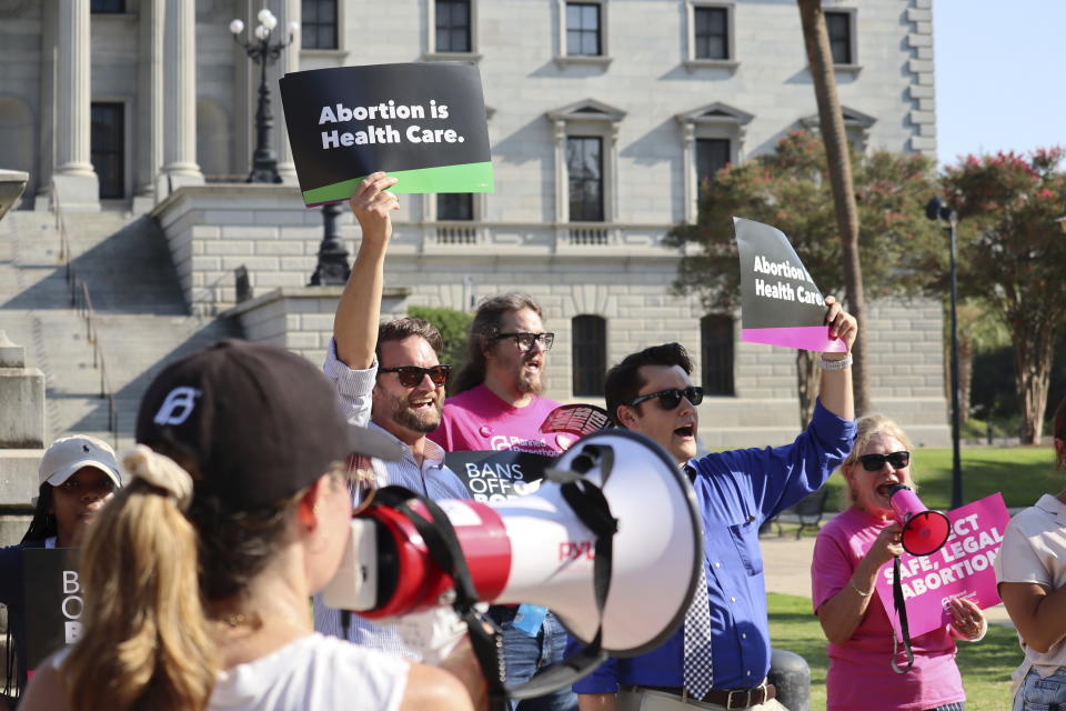 Over two dozen abortion rights supporters attend a rally outside the South Carolina State House in Columbia, S.C., on Wednesday, Aug. 23, 2023. The South Carolina Supreme Court ruled Wednesday to uphold a law banning most abortions except in the earliest weeks of pregnancy. (AP Photo/James Pollard)