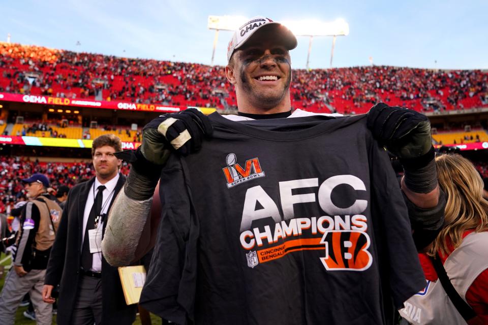 Cincinnati Bengals defensive end Sam Hubbard (94) holds an AFC Championship T-shirt at the conclusion of the AFC championship NFL football game against the Kansas City Chiefs, Sunday, Jan. 30, 2022, at GEHA Field at Arrowhead Stadium in Kansas City, Mo. The Cincinnati Bengals defeated the Kansas City Chiefs, 27-24, to advance to the Super Bowl.
