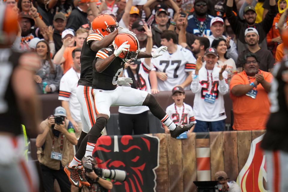 Cleveland Browns wide receivers Amari Cooper, left, and Elijah Moore, right, celebrate a touchdown against the Tennessee Titans on Sunday in Cleveland.