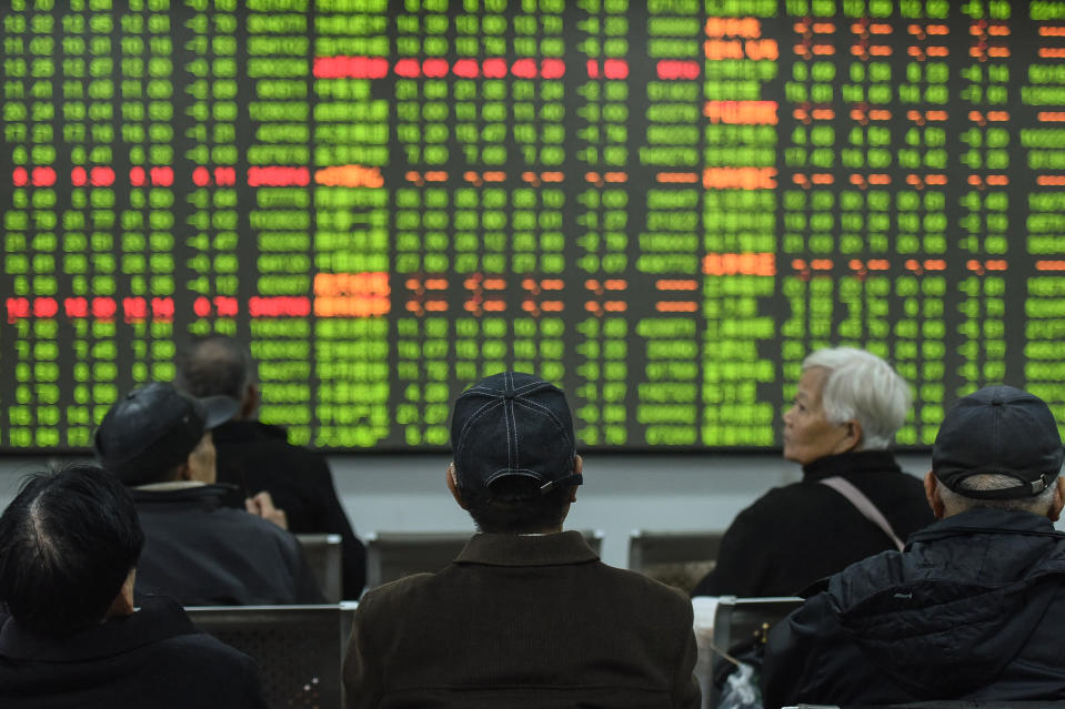 Investors look at a screen showing stock market movements at a securities company in Hangzhou in China's eastern Zhejiang province on February 3, 2020. - Chinese stocks crashed on February 3 with some major shares quickly falling by the maximum daily limit as the country's investors got their first chance in more than a week to react to the spiralling coronavirus outbreak. (Photo by STR / AFP) / China OUT (Photo by STR/AFP via Getty Images)