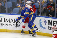 Buffalo Sabres right wing Tage Thompson (72) checks Detroit Red Wings defenseman Danny DeKeyser (65) during the third period of an NHL hockey game, Monday, Jan. 17, 2022, in Buffalo, N.Y. (AP Photo/Jeffrey T. Barnes)