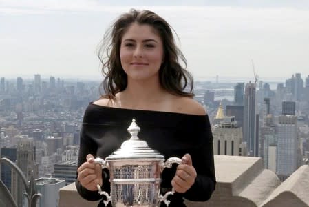 U.S. Open winner Bianca Andreescu poses with her trophy at top of the Rock in New York