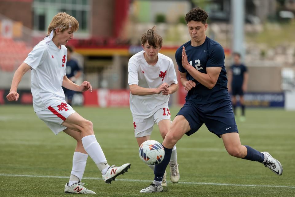 Manti’s Corbin Henry, left, kicks the ball past Juan Diego’s Vladimir Leontieff in a 3A boys soccer state semifinal at Zions Bank Stadium in Herriman on Wednesday, May 10, 2023. | Spenser Heaps, Deseret News