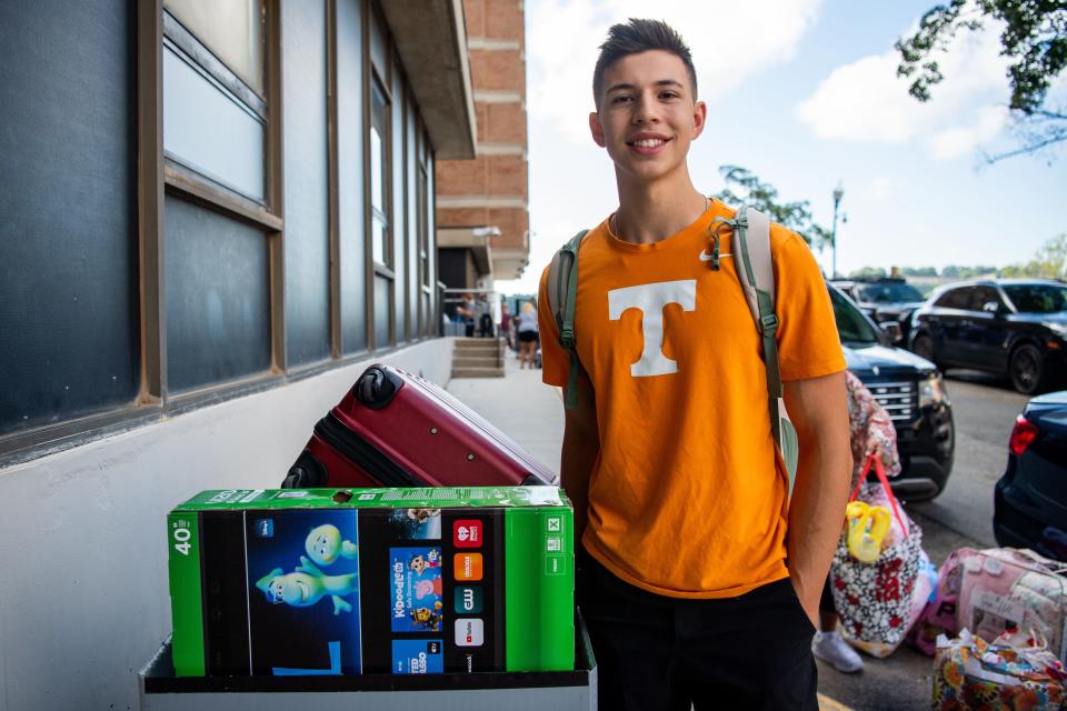 University of Tennessee freshman Shaw Everett poses for a photo with his belongings outside of Carrick Hall during move-in day on Wednesday, August 16, 2023.