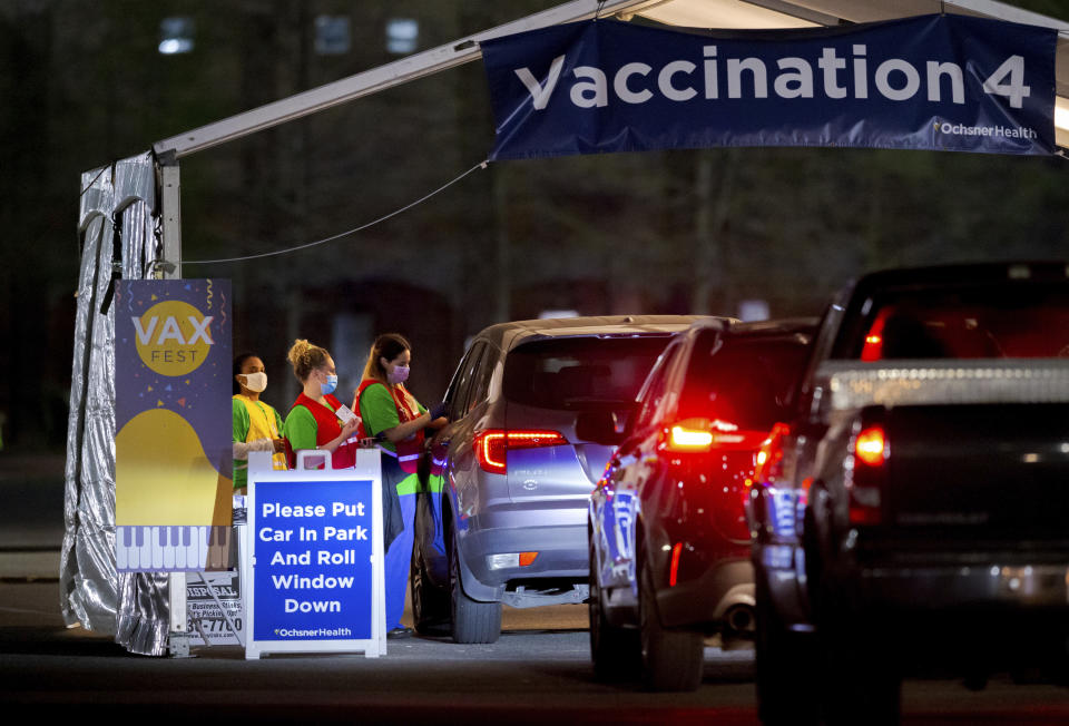 Ochsner nurses and volunteers give a Moderna COVID-19 vaccine at 5 a.m. during the 24-hour Max Fest at the Shrine on Airline in Metairie near New Orleans, Tuesday, March 30, 2021. Anyone who does not have an appointment can show up and get a vaccine until 7 a.m. Louisiana is making a full-court press to get shots in arms, with sometimes creative outreach to make it as easy as possible to get vaccinated. (David Grunfeld/The Times-Picayune/The New Orleans Advocate via AP)