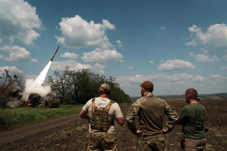 Ukrainian soldiers watch a rocket fire from a HIMARS launcher on May 18, 2023 in Donetsk Oblast, Ukraine.