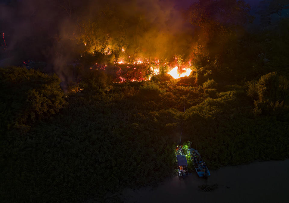 TOPSHOT - Aerial view showing a forest fire raging at the Encontro das Aguas Park by the Sao Lourenco River in the Pantanal wetland, near Pocone, Mato Grosso State, Brazil, on November 12, 2023. Several fires have been ravaging the Brazilian Pantanal, the largest wetland on the planet. According to the specialists, these fires are primarily caused by human action, in particular the use of slash-and-burn techniques for agricultural expansion, and the situation at the end of the year has been exacerbated by an exceptional drought. (Photo by Rogerio FLORENTINO / AFP) (Photo by ROGERIO FLORENTINO/AFP via Getty Images)