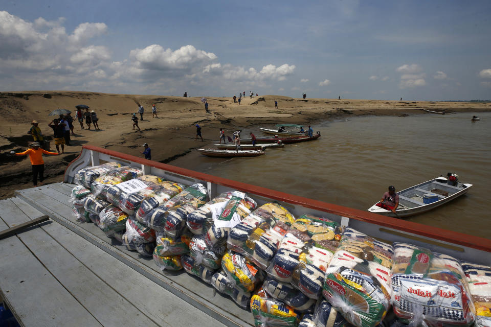 FILE - Packages with food for riverside communities due to the ongoing drought sit on a dock, in Careiro da Varzea, Amazonas state, Brazil, Tuesday, Oct. 24, 2023. On Tuesday, the municipality distributed emergency kits using an improvised barge originally designed to transport cattle. (AP Photo/Edmar Barros, File)