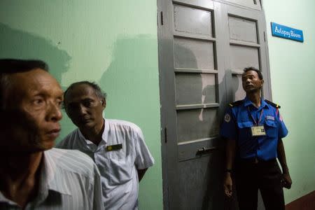 A policeman stands guard at the forensic department of a hospital where the body of Ko Ni is kept in Yangon, Myanmar, January 29, 2017. REUTERS/Aung Kyaw Htet/Files