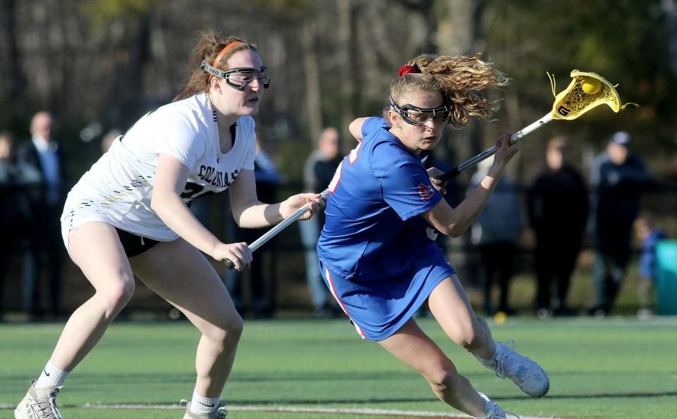 Ashland sophomore Anna Magennis controlled the ball against Acton-Boxborough's Cailey Ryan, April 4, 2022.