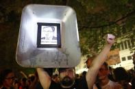 A man holds a cart with a pasted image of Poland's Minister of Justice Zbigniew Ziobro during protest against supreme court legislation outside the Parliament in Warsaw, Poland, July 21, 2017. REUTERS/Kacper Pempel