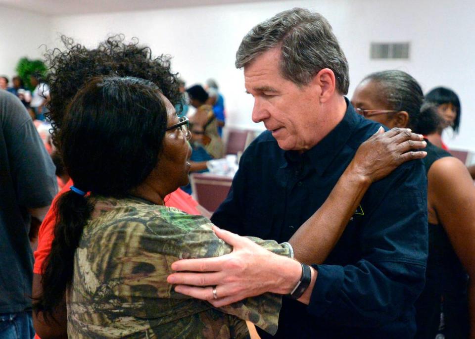 N.C. Governor Roy Cooper talks with Joyce Davis at an event feeding victims of Hurricane Florence at the Bright Hopewell Baptist Church in Laurinburg in Sept. 2018. Cooper was on a tour of agricultural areas hit hard by the storm.