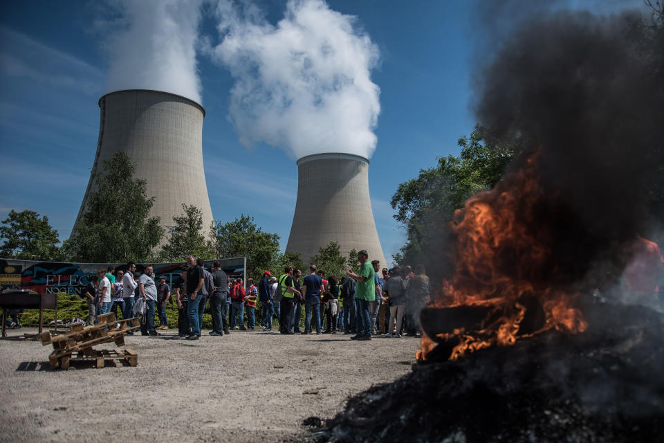 <p>Trade unionists block the entrance of the Nogent Nuclear Power Plant with burning objects to protest against the French labor reform law, in Nogent sur Seine, France, May 26, 2016. A strike hits oil refineries, fuel depots, petrol stations and nuclear plants across France. (CHRISTOPHE PETIT TESSON/EPA) </p>