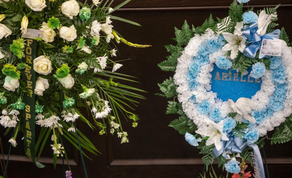 Two wreath floral arrangements with the words 'Forever Spartan' and Arielle written in the middle of each arrangement sit inside the Zion Hope Baptist Church during Arielle Diamond Anderson's church service in Detroit on Feb. 21, 2023.