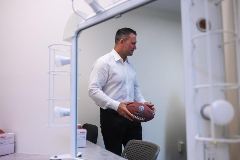 Former Miami Dolphins linebacker Zach Thomas holds a signed football backstage during the Palm Beach Post High School Sports Awards ceremony at the Kravis Center in West Palm Beach, FL., on Wednesday, May 1, 2022.
