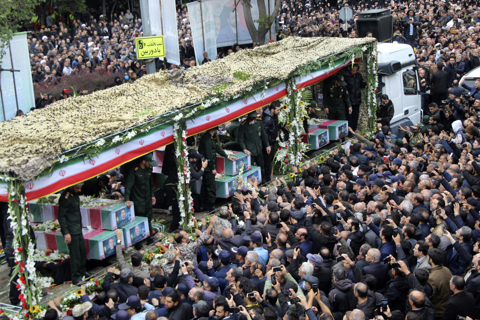 In this photo provided by Fars News Agency, mourners gather around a truck carrying coffins of Iranian President Ebrahim Raisi and his companions who were killed in their helicopter crash on Sunday in mountainous region of the country's northwest, during a funeral ceremony at the city of Tabriz, Iran, Tuesday, May 21, 2024. Mourners in black began gathering Tuesday for days of funerals and processions for Iran's late president, foreign minister and others killed in a helicopter crash, a government-led series of ceremonies aimed at both honoring the dead and projecting strength in an unsettled Middle East. (Ata Dadashi/Fars News Agency via AP)