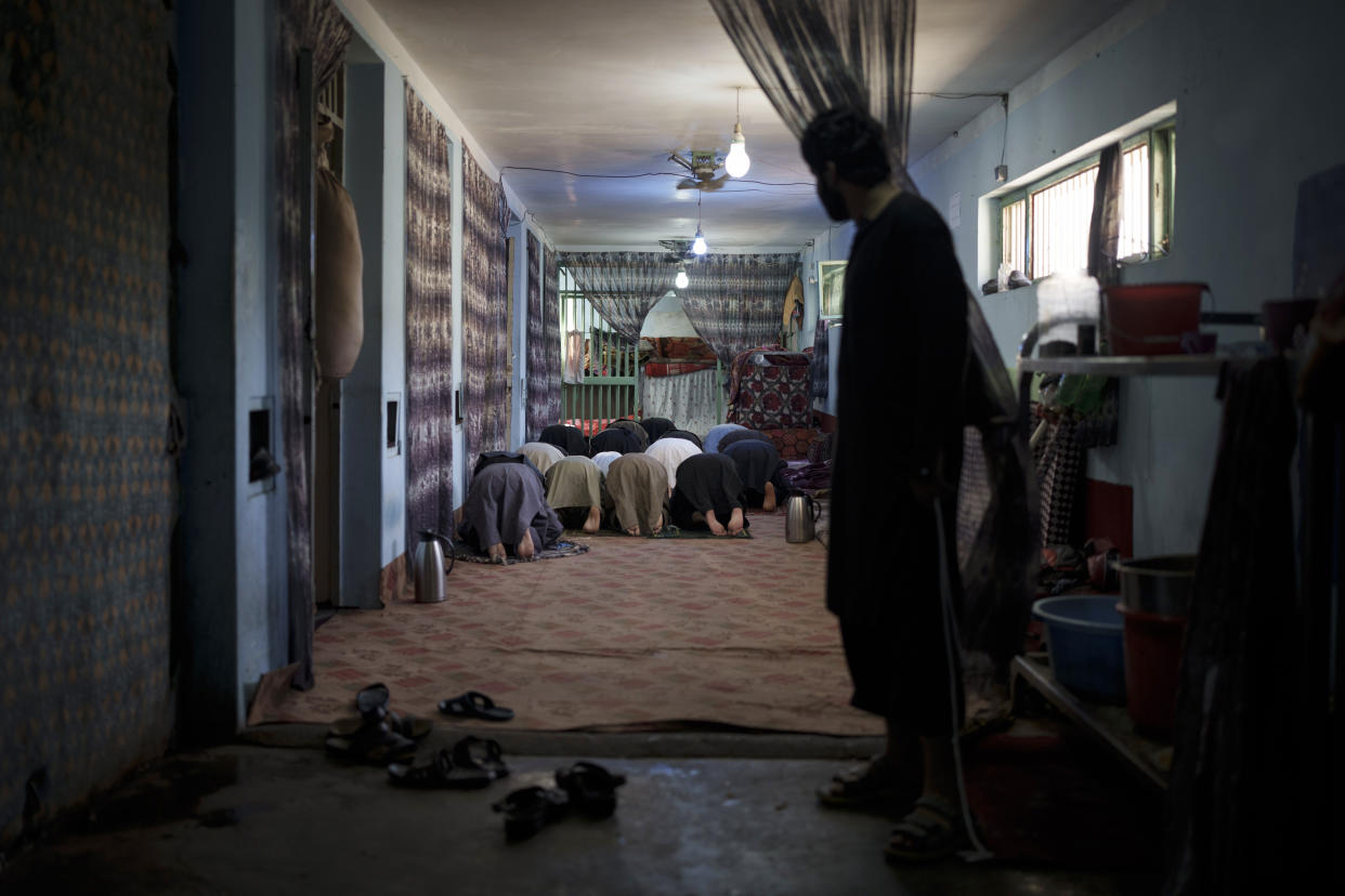 Recently arrested prisoners pray inside the Pul-e-Charkhi prison in Kabul, Afghanistan, Monday, Sept. 13, 2021. Pul-e-Charkhi was previously the main government prison for holding captured Taliban and was long notorious for abuses, poor conditions and severe overcrowding with thousands of prisoners. Now after their takeover of the country, the Taliban control it and are getting it back up and running, current holding around 60 people, mainly drug addicts and accused criminals. (AP Photo/Felipe Dana)