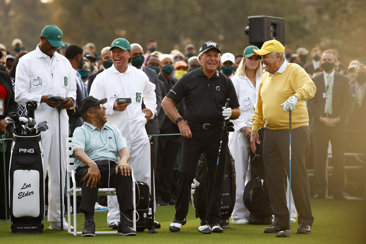 Lee Elder (seated) receives recognition as Wayne Player holds up a sleeve of golf balls behind him at the Masters in 2021. (Jared C. Tilton/Getty Images)