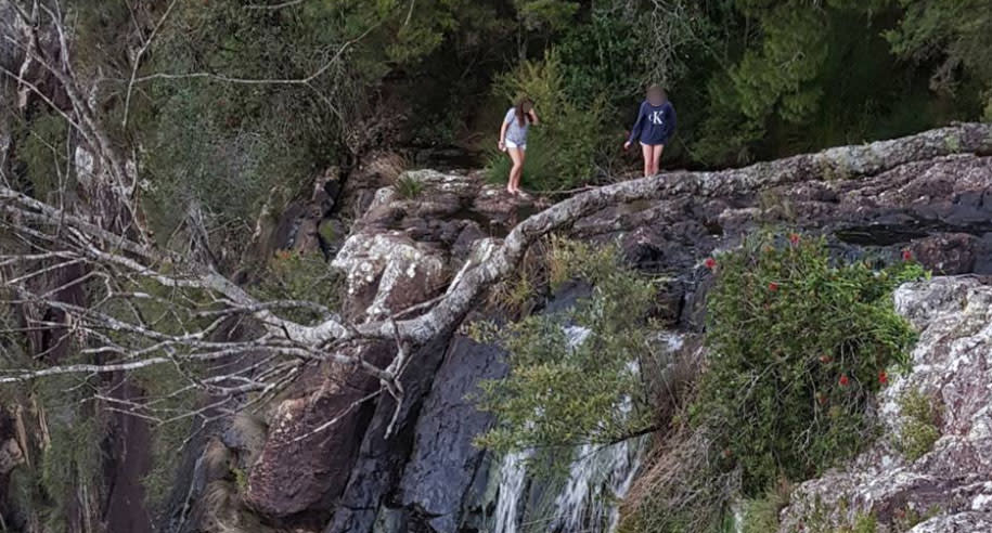 Witnesses watched on in shock while two women stood at the edge of the cliff to take the perfect selfie. Source: Facebook