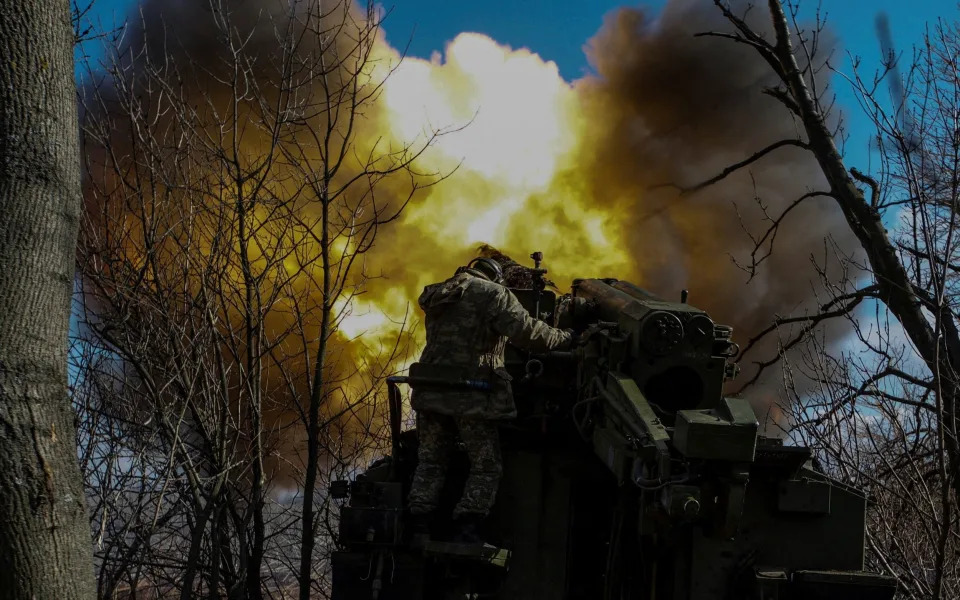 Ukrainian servicemen fire a 2S5 Giatsint-S self-propelled howitzer towards Russian troops outside the frontline town of Bakhmut - Reuters