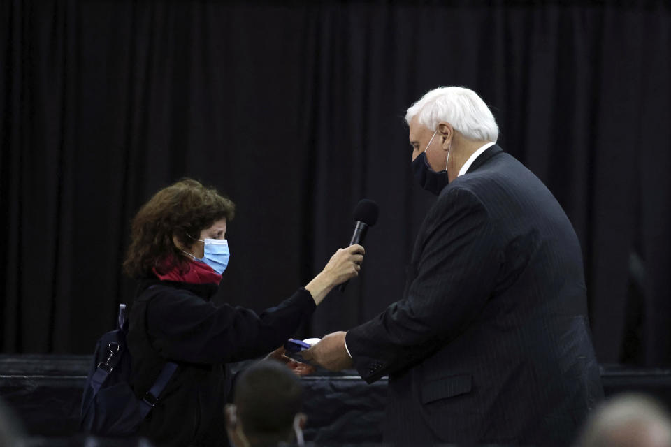 West Virginia Gov. Jim Justice, right, presents Victoria Yeager, the wife of the late Air Force Brig. Gen. Chuck Yeager the state flag during a memorial service for him in Charleston, W.Va., on Friday, Jan. 15, 2021. Yeager died last month at age 97. The West Virginia native in 1947 became the first person to fly faster than sound. (AP Photo/Chris Jackson)