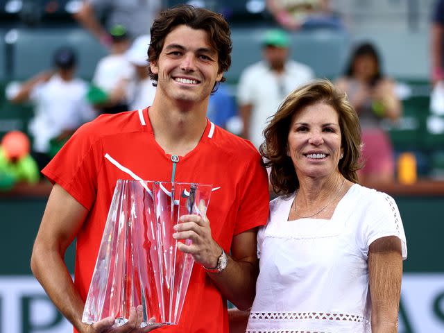 <p>Clive Brunskill/Getty </p> Taylor Fritz and Kathy May after the men's final on day 14 of the BNP Paribas Open on March 20, 2022 in Indian Wells, California.