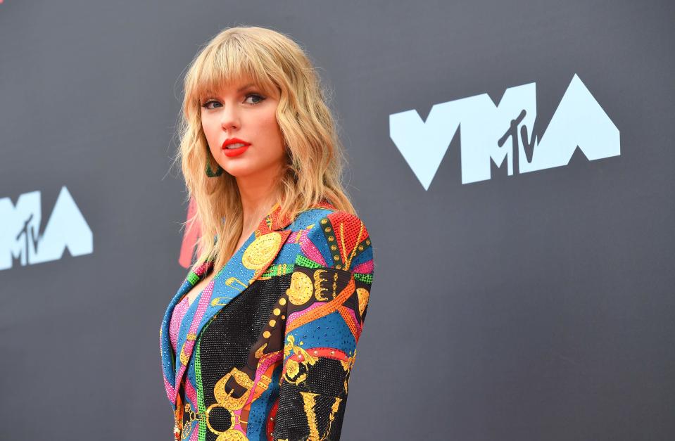 Taylor Swift says the owners of her back catalog of music won't let her perform those songs at the American Music Awards.