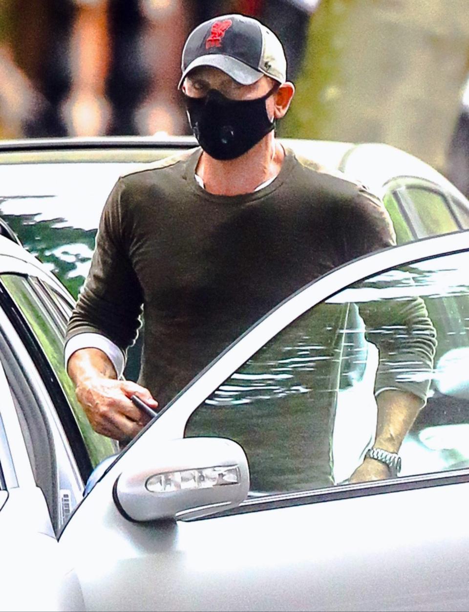 <p>Daniel Craig is seen getting into his car while running errands in a baseball cap and face mask in N.Y.C. on Monday.</p>