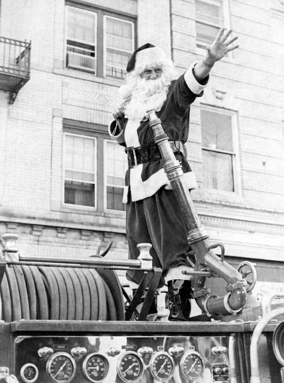 Santa Claus arrives in Ridgewood, N.J., atop a fire engine on November 29, 1981, signaling the beginning of the holiday shopping season. Village stores will be open 10 a.m. to 9 p.m. Monday through Friday, and 10 a.m. to 6 p.m. Saturdays, through Christmas Eve.