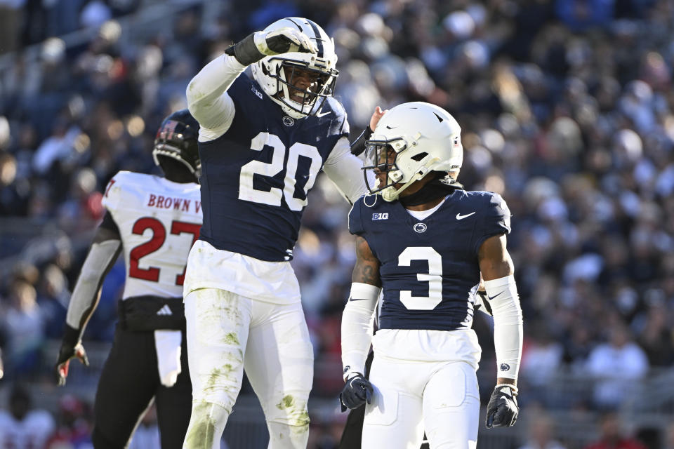 Penn State cornerback Johnny Dixon (3) celebrates with Adisa Isaac (20 after sacking Rutgers quarterback Gavin Wimsatt (2) during the second half of an NCAA college football game, Saturday, Nov. 18, 2023, in State College, Pa. (AP Photo/Barry Reeger)